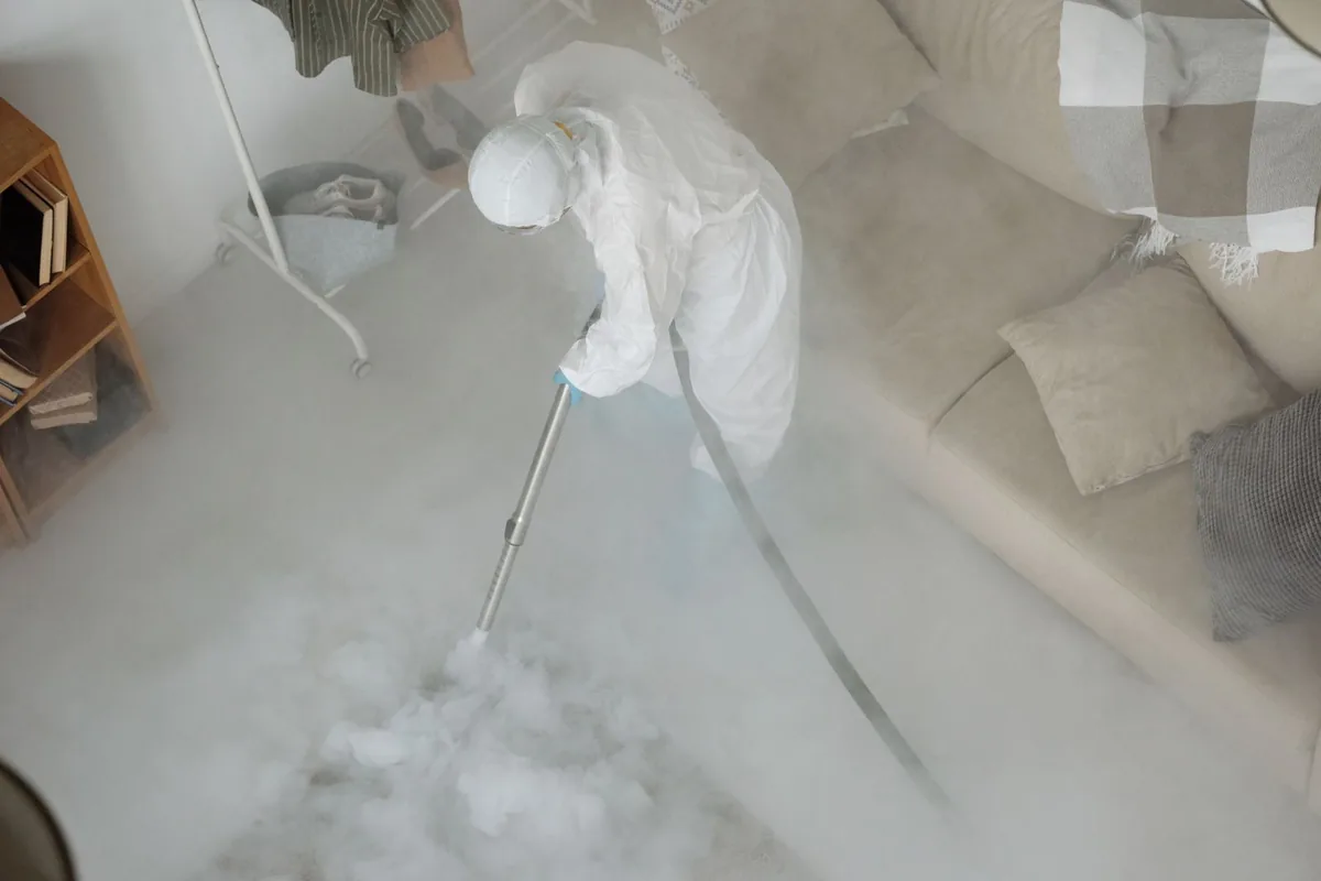 Biohazard cleanup technician in protective equipment, Deep River Center, CT
